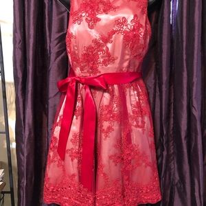 Super cute lace dress with cot out back, and satin belt